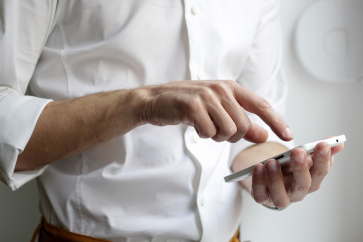 A man using his mobile phone to conduct Mobile healthcare fieldwork
