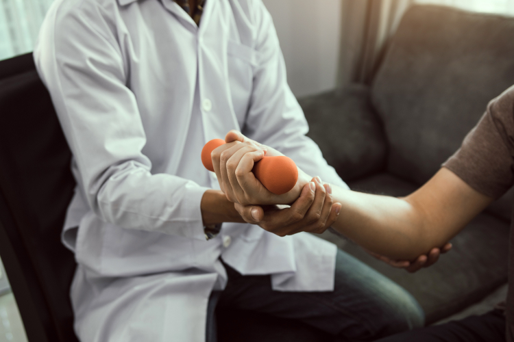 Doctor with a patient who is lifting a small weight