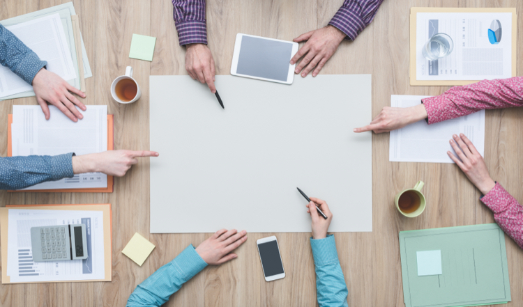 A group of people around a table managing a project