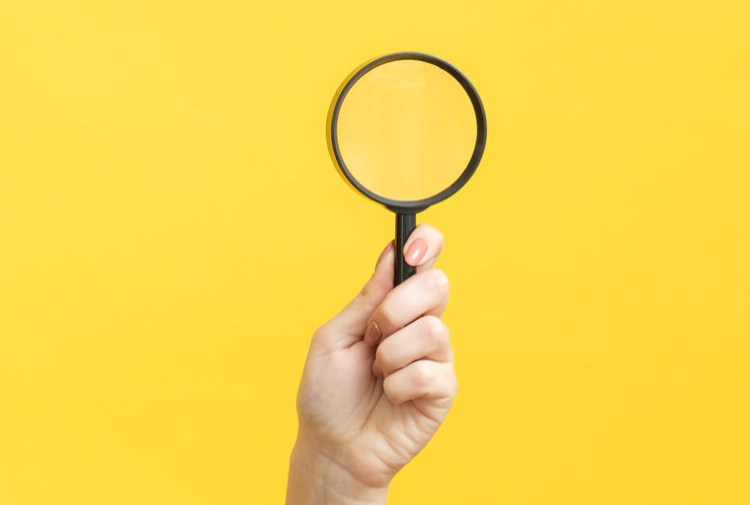 A magnifying glass to illustrate healthcare fieldwork services recruitment