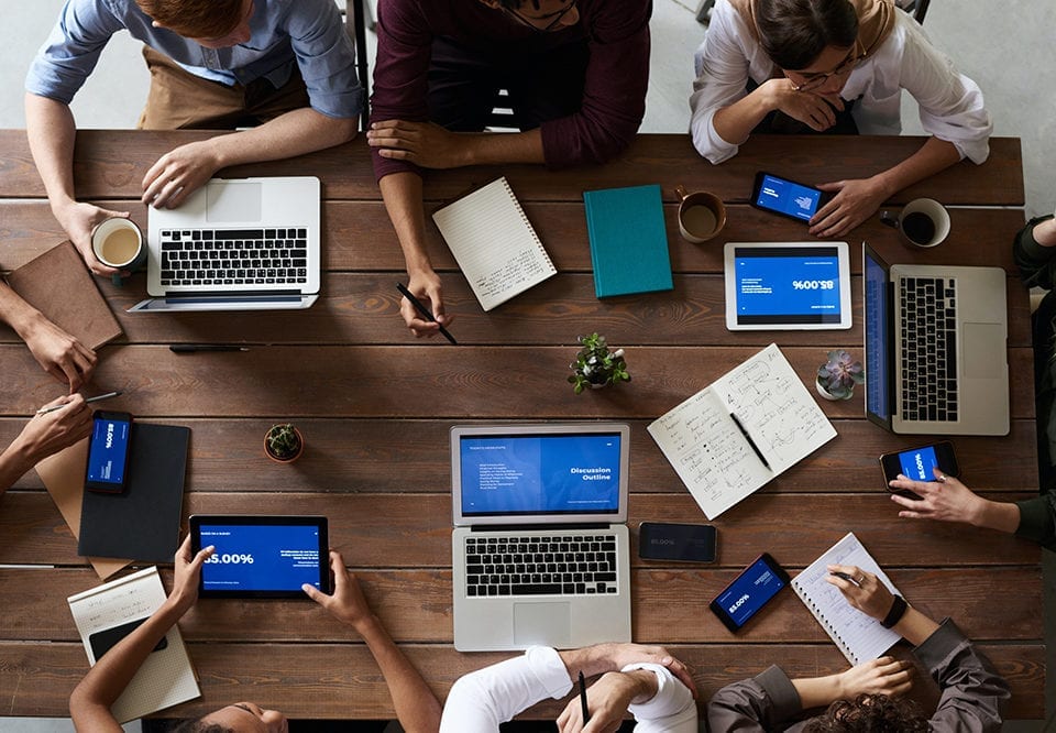 people-sitting-at-meeting-table-960x666